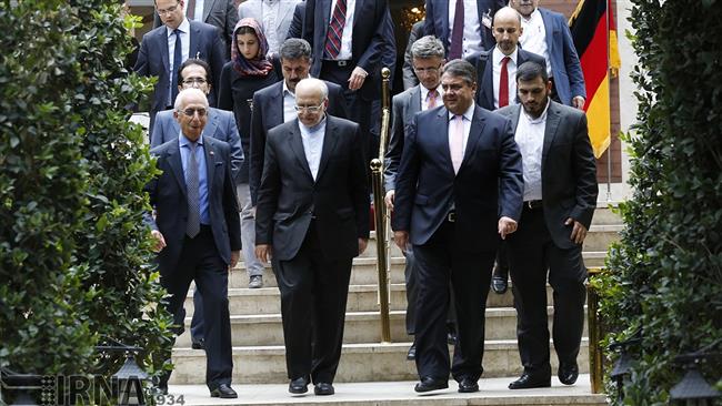 Iran's Industry Minister Mohammad Reza Nematzadeh (2nd L) and German Economy Minister Sigmar Gabriel (2nd R) are leaving a meeting after talks in Tehran. 