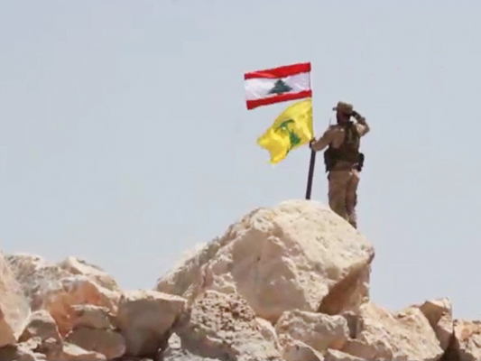 Hezbollah Takes Down ISIS Flag on Syrian Border