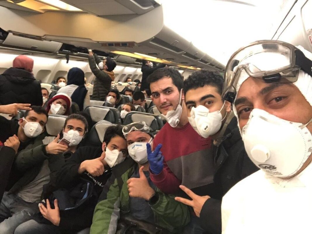 Iranian students pose for a photo during a flight that evacuated them from the Chinese city of Wuhan, the epicentre of the novel coronavirus