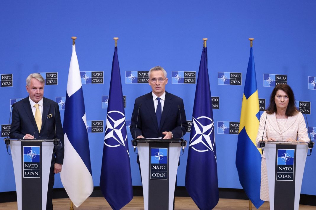Finnish Foreign Minister Pekka Haavisto, left, NATO Secretary General Jens Stoltenberg, center, and Swedish Ministry for Foreign Affairs Anne Linde, right, give a press conference after the signing of the accession protocols of Finland and Sweden at the NATO headquarters in Brussels, Belgium.