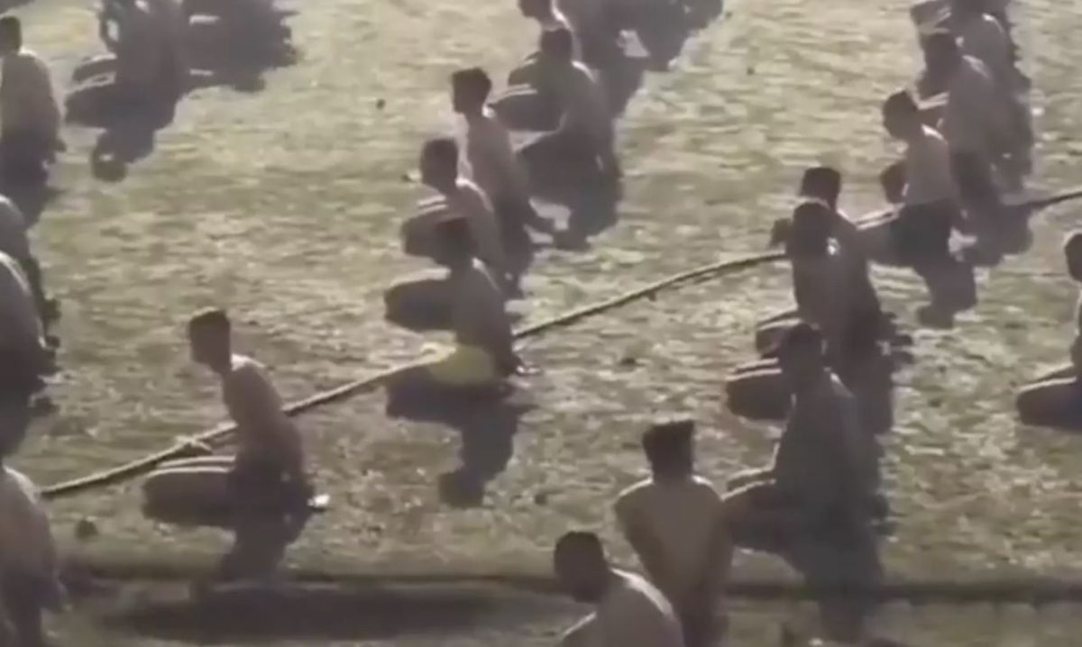 Israeli soldiers round up stripped Palestinian men and children at stadium